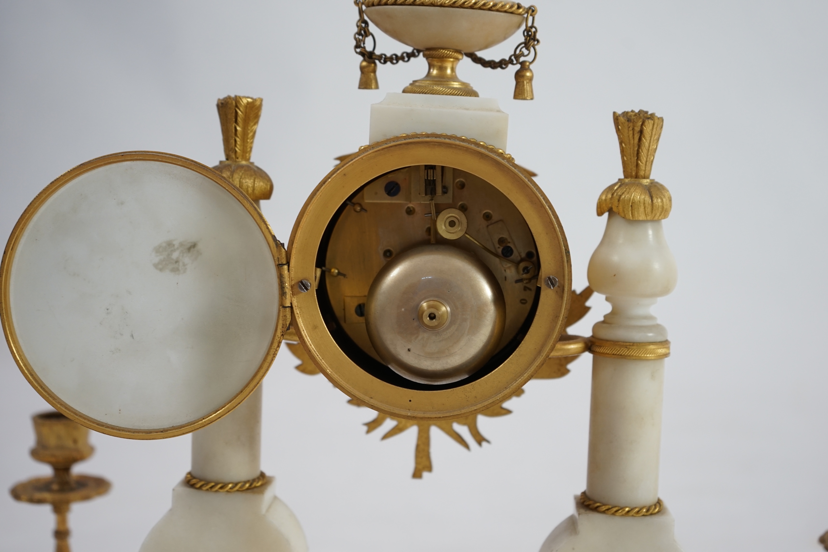 An early 20th century French ormolu mounted white mounted portico clock